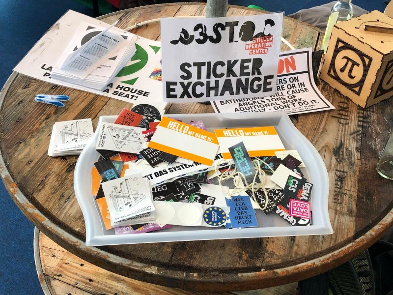 photo of a small but lovely sticker box with a sticker exchange sign at the tea tent